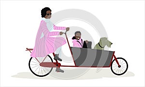 Mother carrying her child and dog on a cargo bike bakfiets. African American lady riding bicycle with from passenger sit photo