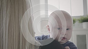 Mother carrying son inside room