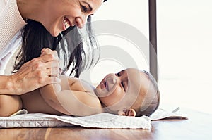 Mother changing diaper to toddler