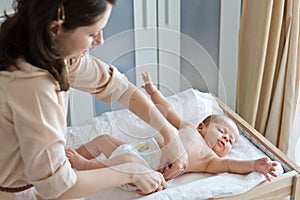 Mother changing diapers photo