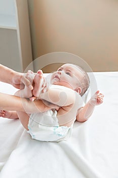 Mother changing the nappy of her baby at home