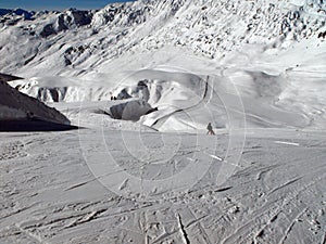 Mother and child alone on a sunny ski slope.