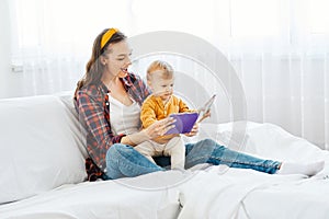 mother child baby bood reading education learning having fun family happy childhood care boy sun