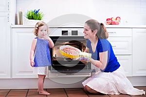 Mother and child baking a cake.