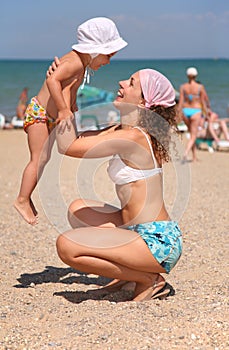 Mother with child on a beach