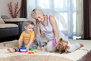 Mother, child boy and dog playing indoor
