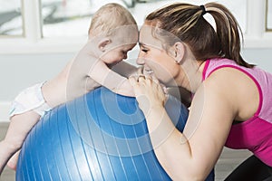 Mother with child boy doing fitness exercises