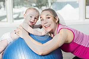 Mother with child boy doing fitness exercises