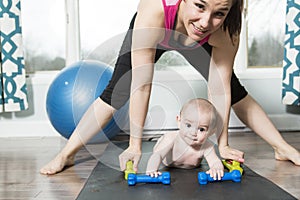 Mother with child boy doing fitness exercises