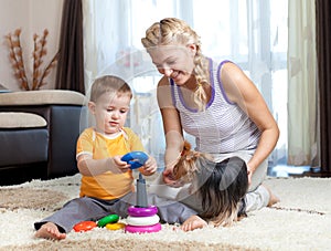 Mother, child boy and pet dog playing