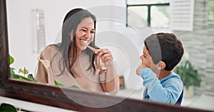 Mother, child and brushing teeth in bathroom with mirror, morning routine and dental with toothpaste for fresh breathe