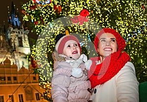 Mother and child in Christmas Prague looking into the distance