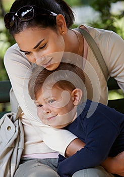 Mother and child cuddling in park