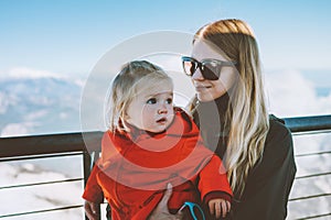 Mother with child daughter traveling together family winter vacation mom with baby