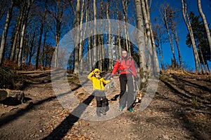 A mother with a child and a dog are walking along the mountain hiking trail. Family spending time