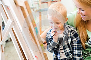 Mother and child draw a picture paints, art lesson