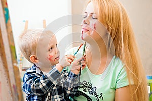 Mother and child draw a picture paints, art lesson