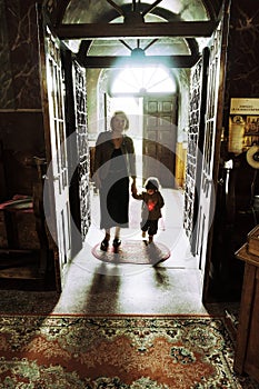 Mother and child entering in a church