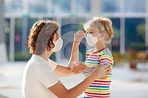 Mother and child with face mask and hand sanitizer