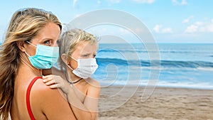 Mother, child in face masks on tropical sea beach