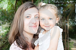 Mother and child girl daughter with blue eyes