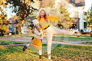 Mother and child girl haing fun together. Happy family enjoying autumn day. Family autumn walk