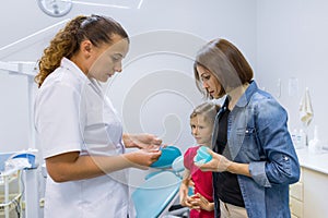 Mother and child girl in meeting with doctor orthodontist