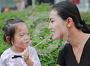 Mother and child girl playing bubble gum. Happy loving family