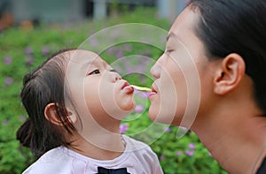 Mother and child girl playing bubble gum. Happy loving family