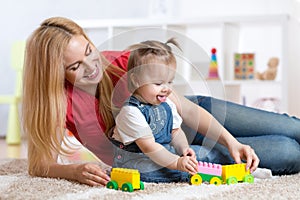 Mother and child girl playing together indoor