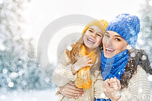 Mother and child girl on a winter walk