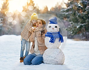 Mother and child girl on a winter walk