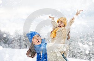 Mother and child girl on a winter walk