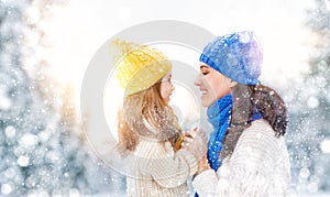 Mother and child girl on a winter walk