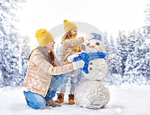 Mother and child girl on a winter walk