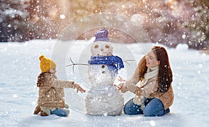 Mother and child girl on a winter walk in nature