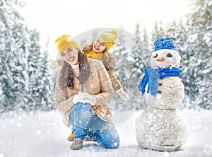 Mother and child girl on a winter walk in nature