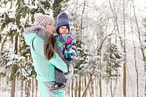 Mother and child girl on a winter walk in nature. Happy family