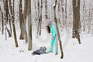 Mother and child girl on a winter walk in nature. Happy family