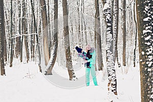 Mother and child girl on a winter walk in nature. Happy family