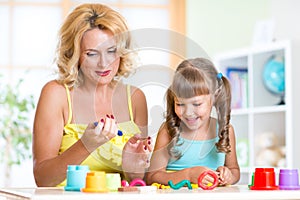 Mother and child have fun with colorful play clay