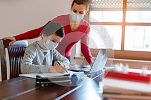 Mother and child having e-learning session with teacher during crisis