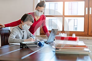 Mother and child having e-learning session with teacher during crisis