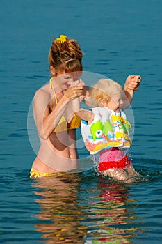 Mother and child having fun at sea