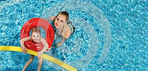 mother with child having fun in swimming pool. copy space