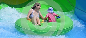 Mother and child having fun in water park