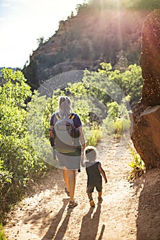 Mother and child hiking on a scenic mountain trail