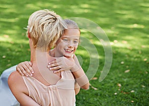 Mother, child and hug on garden grass for bonding connection in park for relax, parenting or summer. Woman, back and