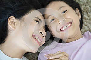 Mother and child lying on the carpet