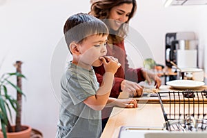 Mother and child making chocolate peanut cookies for quarantine